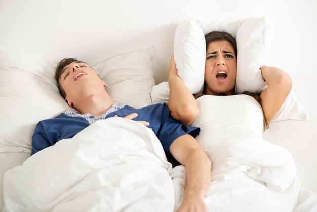 woman losing sleep because of a snoring partner