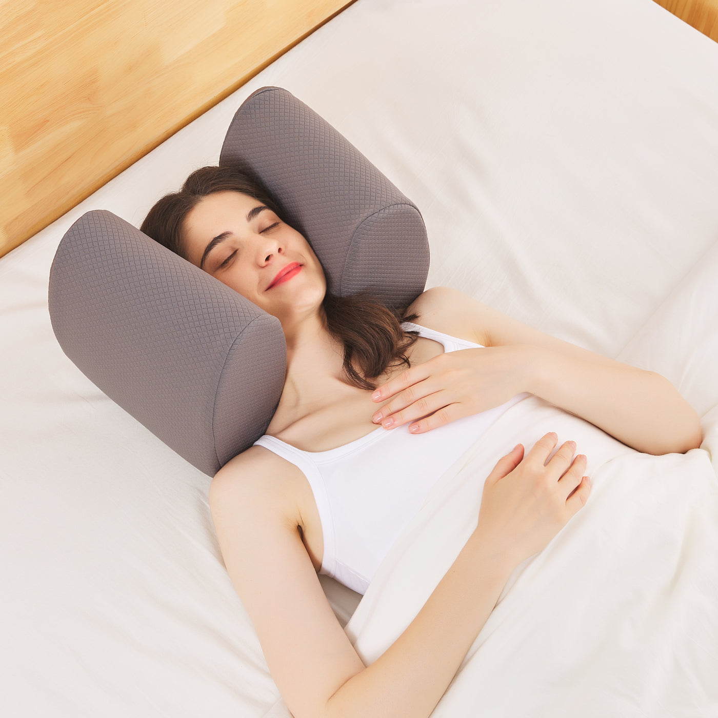 a woman comfortably sleeping with a sound cancelling, sleep headphone pillow