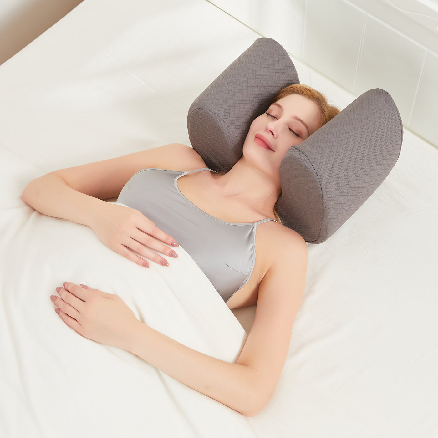 young woman sleeping comfortably in her soli pillow with headphones