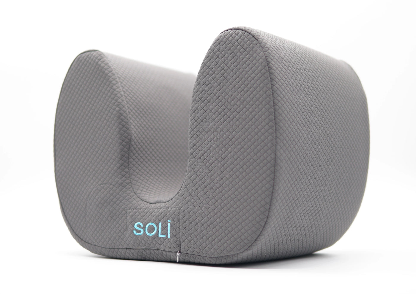 young woman listening to music and relaxing with her Soli pillow