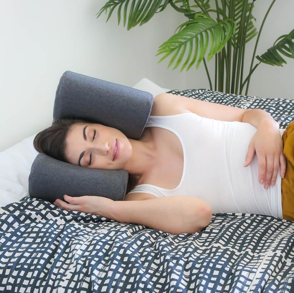 a woman is sleeping through loud noises while using a noise cancelling pillow with headphones