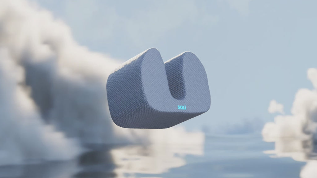 Soli - The noise cancelling pillow with headphones is floating in a cloudy dream scene